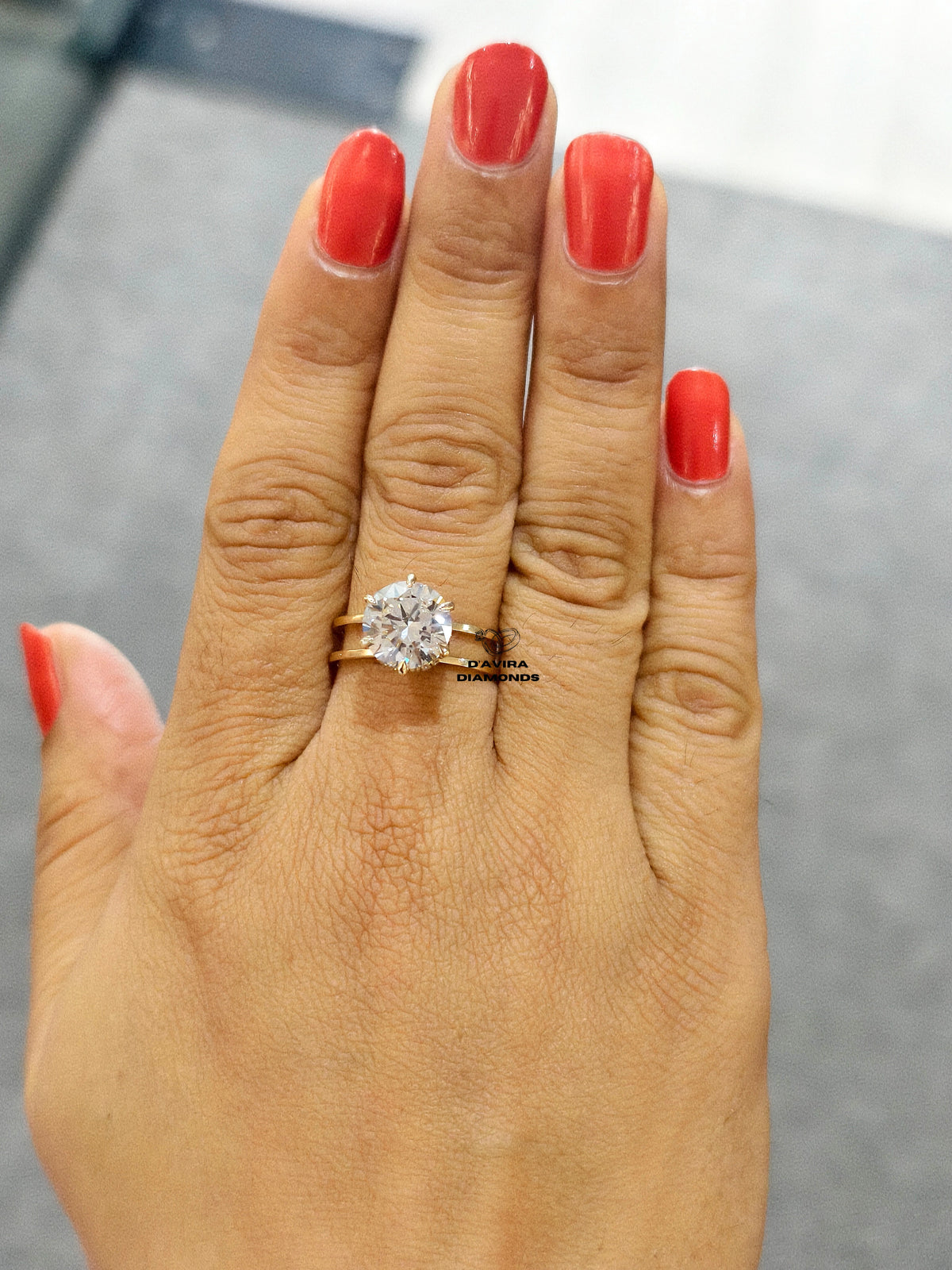  front view of the gold solitaire ring a round cut gemstone set on a double or split-shank band