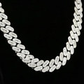 close up of a diamond Cuban link chain over a black background