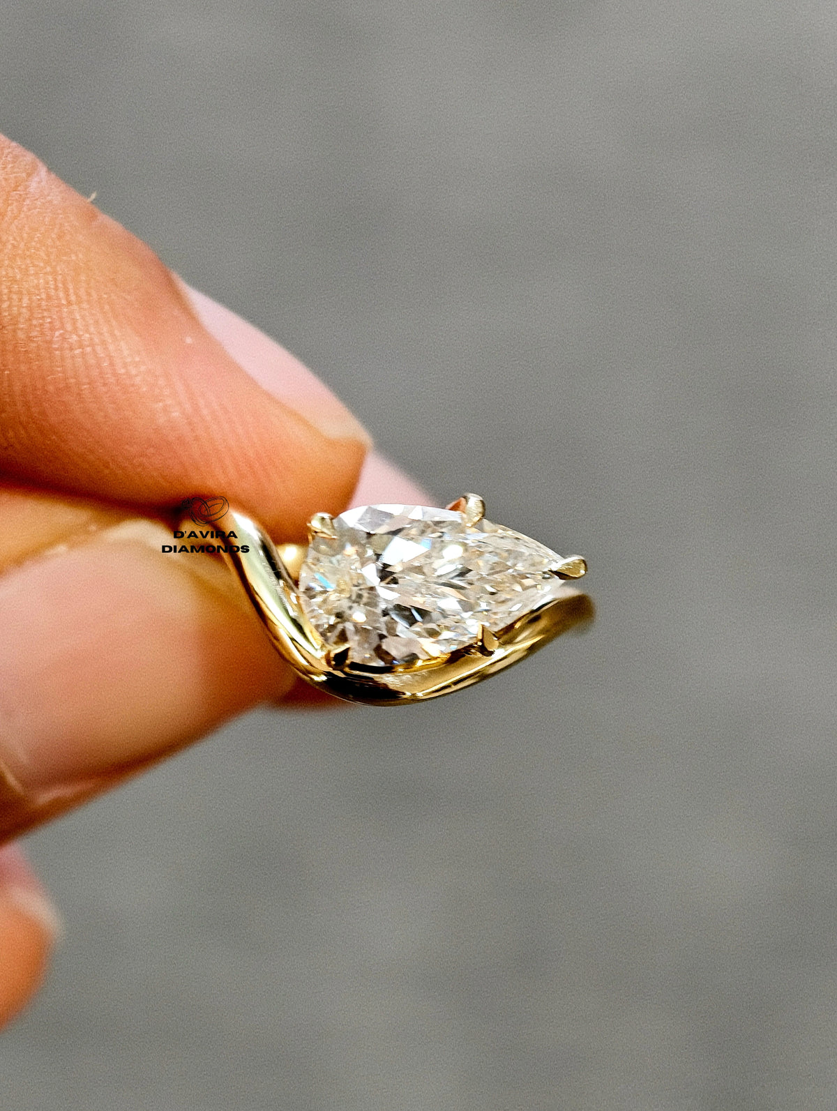 front view of the east west pear cut lab grown diamond ring
