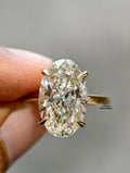  front view of the Large oval cut diamond with a yellow gold band and four prongs