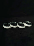 Four silver iced-out bands pave diamond multi-finger hip-hop rings lined up on a black background
