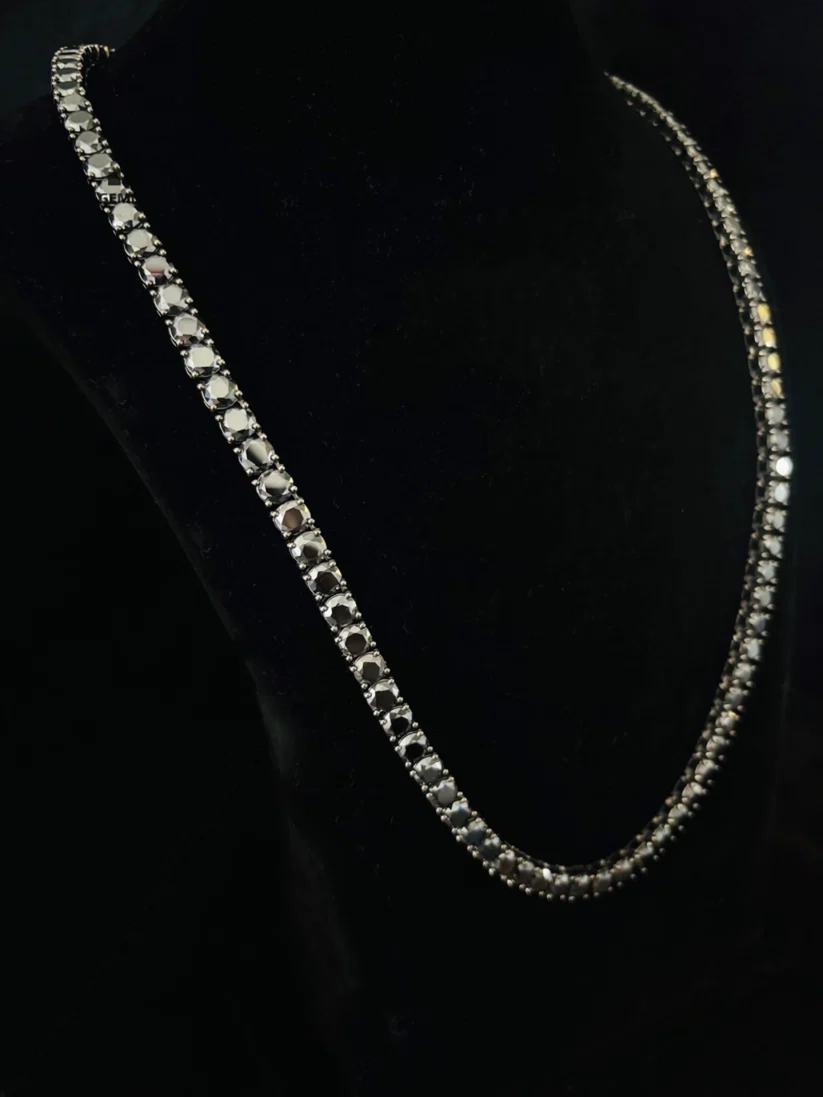 Single strand round cut diamond tennis necklace in a silver prongs setting