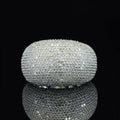 A wide sterling silver pave diamond dome ring featuring tightly set round-cut stones