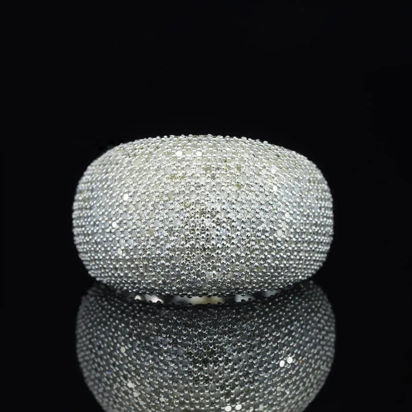 A wide sterling silver pave diamond dome ring featuring tightly set round-cut stones