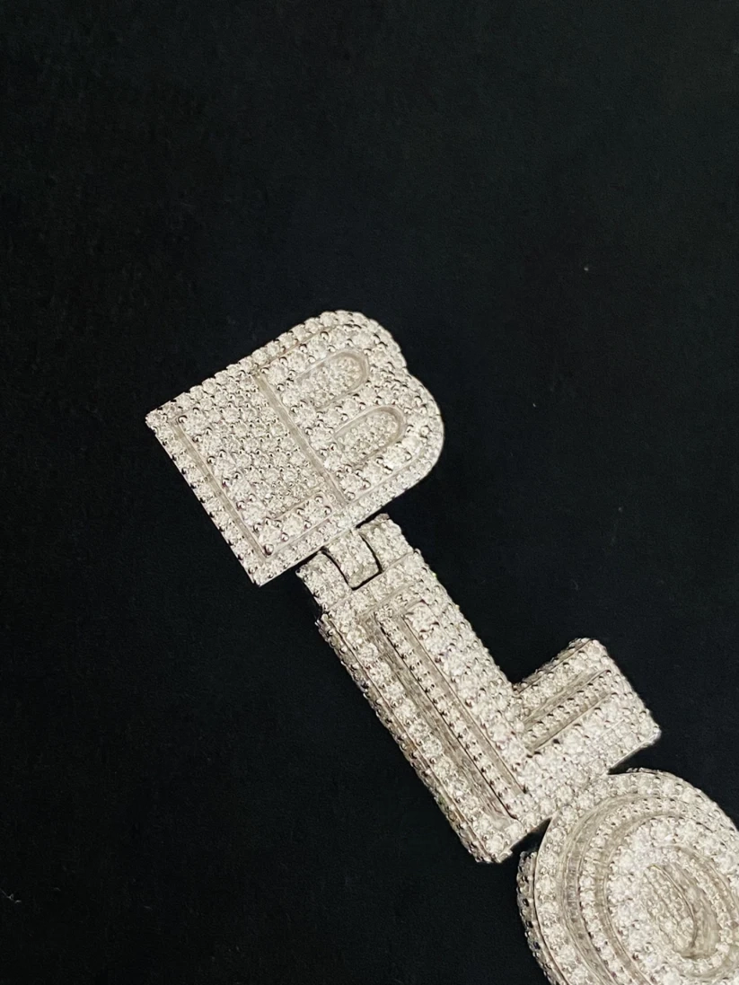 Custom iced-out vertical letters pendant in white gold with pave and baguette diamonds