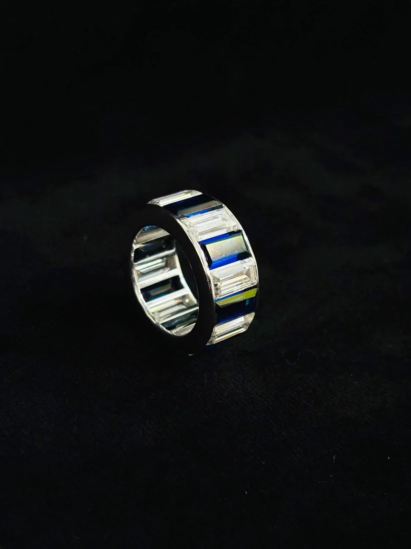 A polished silver ring with rectangular inlay segments in blue diamond