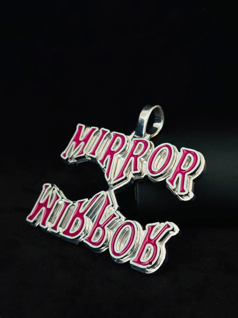 Custom silver hip hop jewelry pendant featuring mirror mirror pink lettering