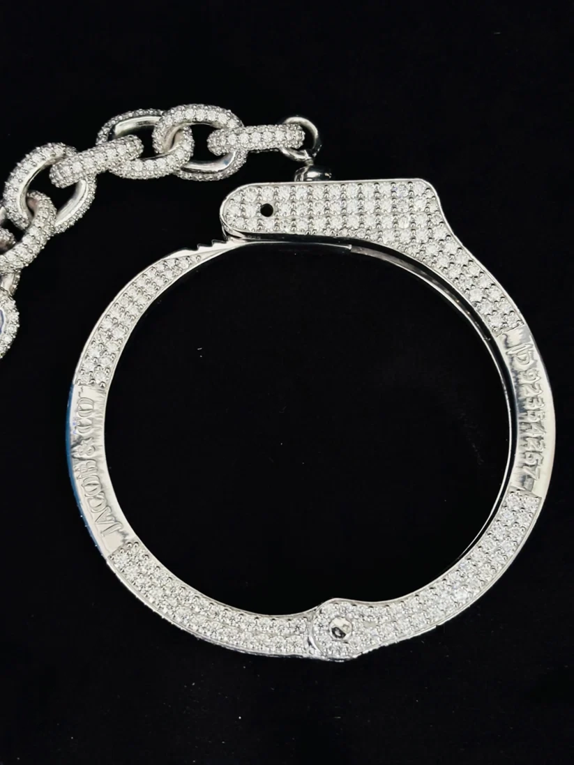 Silver Hip-Hop handcuff-shaped pendant with gemstones on a black background