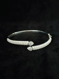 A front view Silver bypass cuff bracelet adorned with pave-set and two pear-cut diamond accents