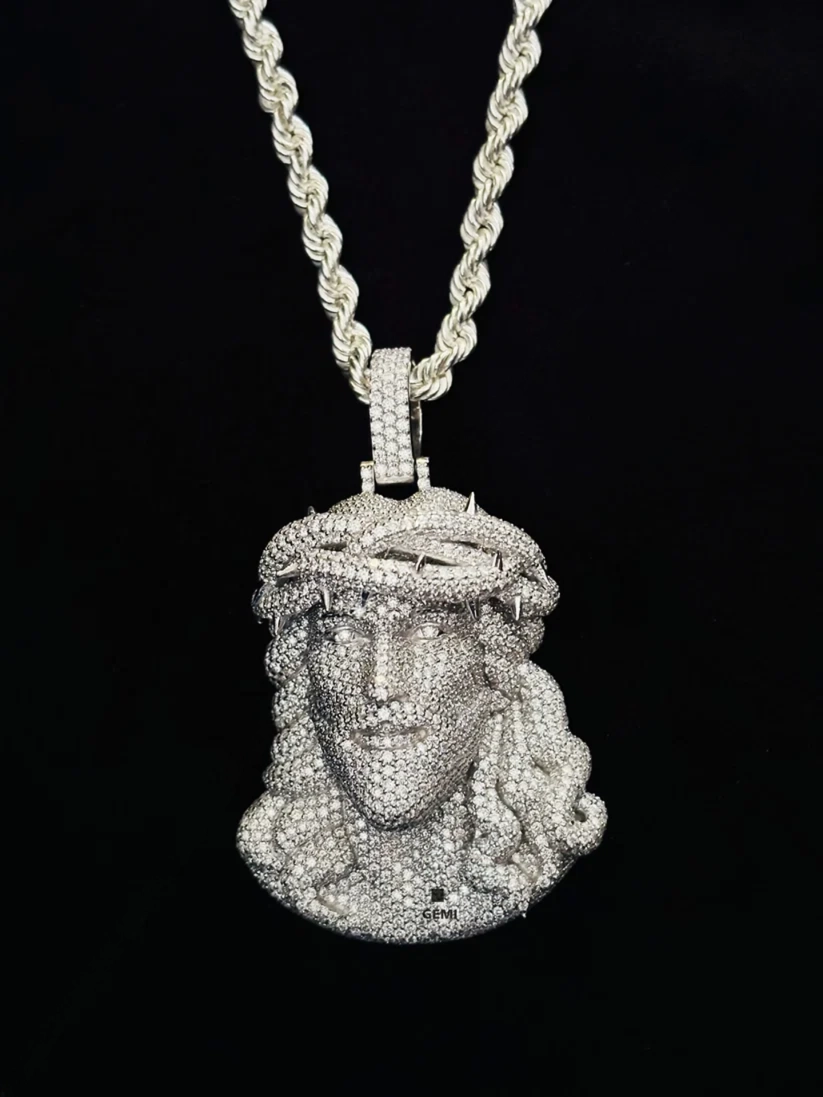 front view Iced out diamond Jesus piece pendant on a silver rope chain.