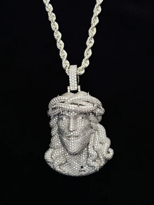 front view Iced out diamond Jesus piece pendant on a silver rope chain.