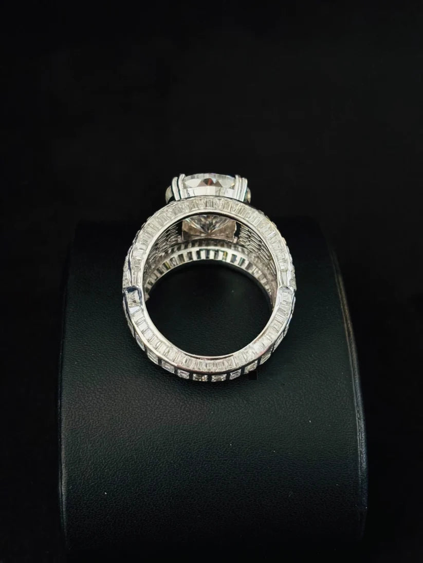 a back view Large solitaire diamond ring with baguette-cut accents on a wide band