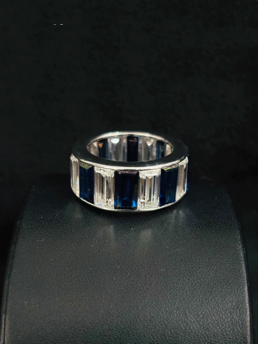 A silver ring featuring baguette-cut and rectangular dark blue stones