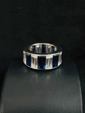 A silver ring featuring baguette-cut and rectangular dark blue stones