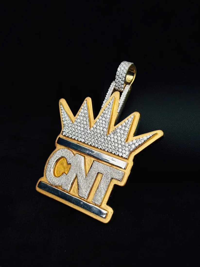 side view Custom iced-out crown pendant necklace with CNT diamond-encrusted lettering in yellow and white gold.
