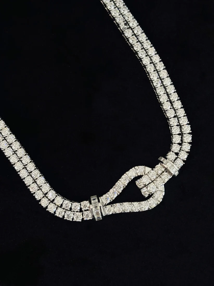 close up of a Two-row diamond tennis necklace with paved buckle accent