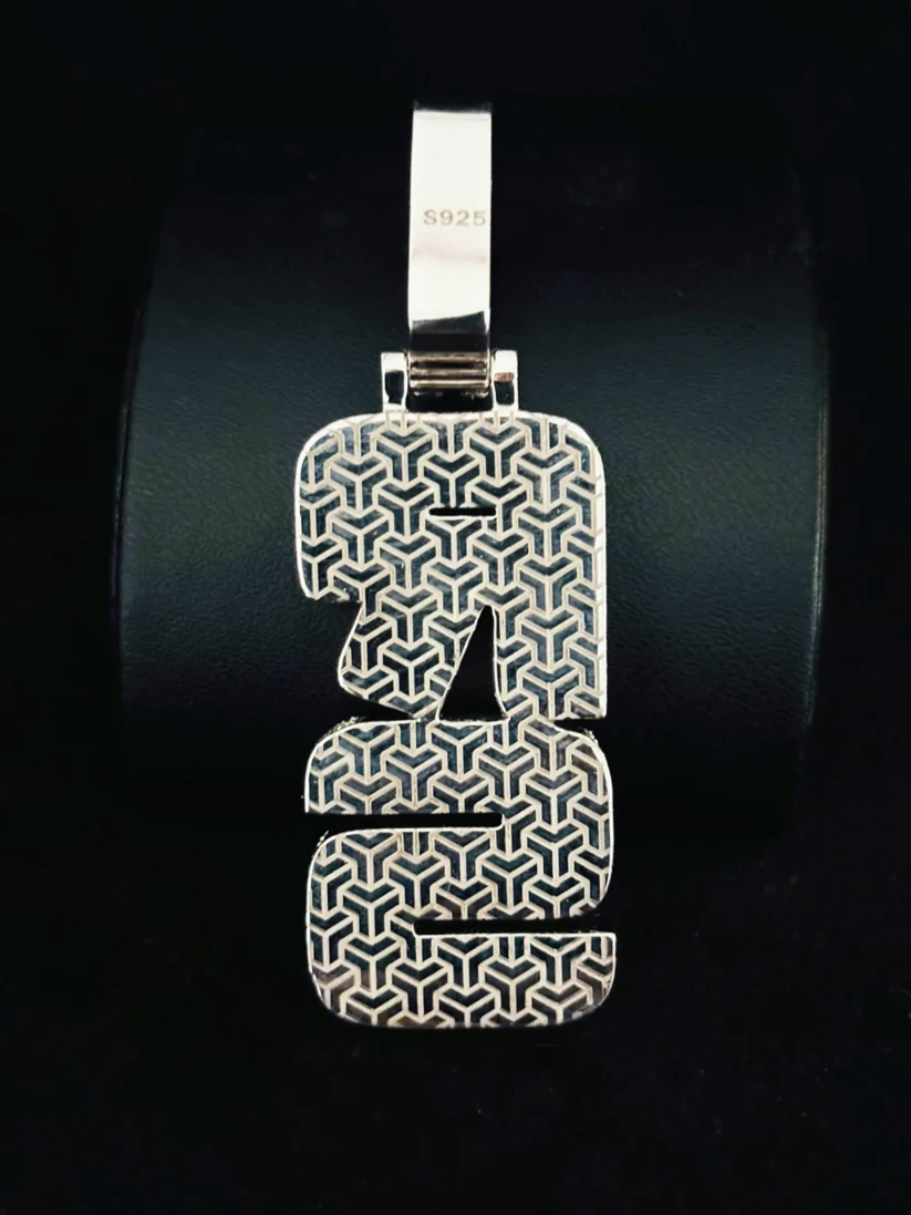 Sterling silver hip hop style custom initial number pendant with geometric engraving.