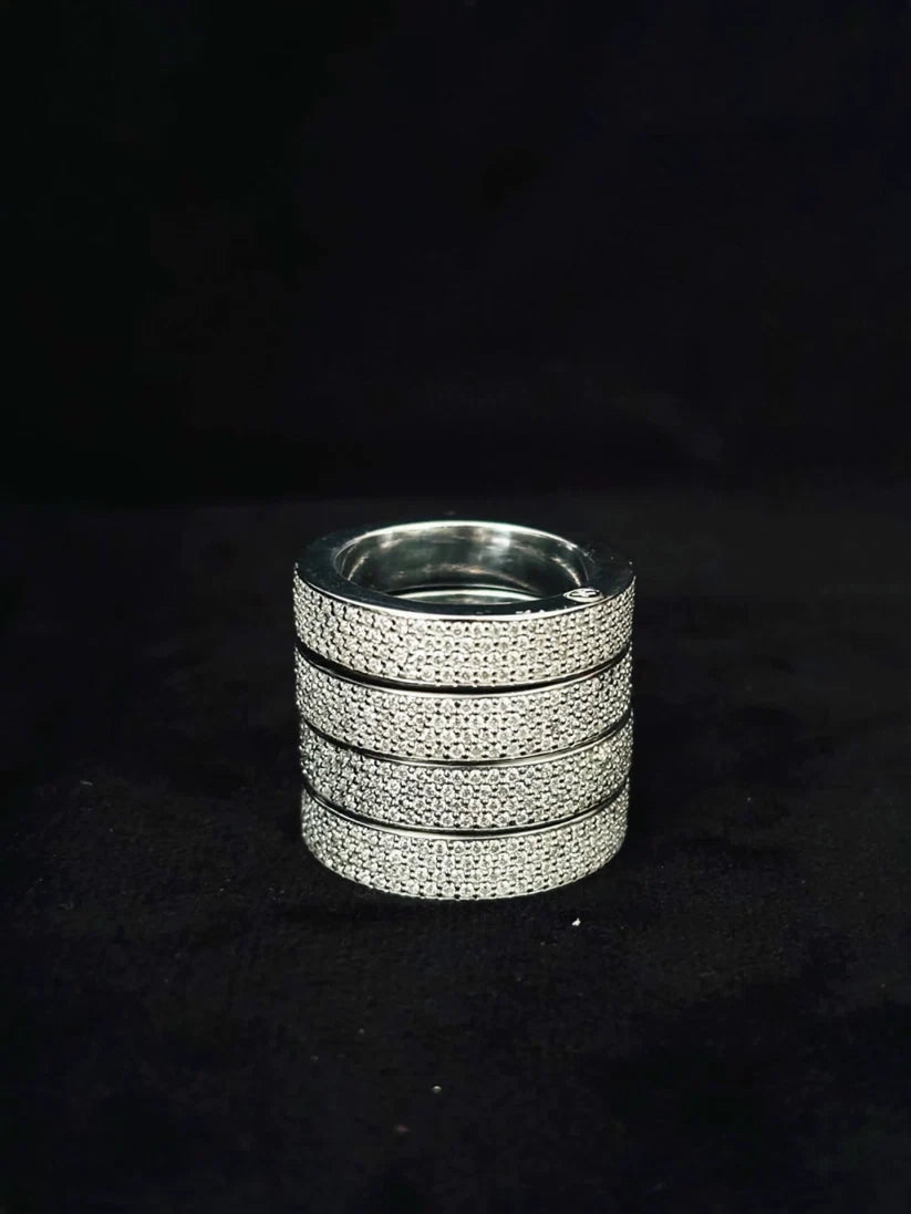 Four stacked silver diamond pave wedding bands displaying a multi-row eternity ring style