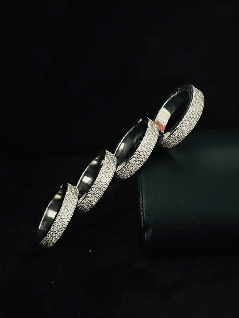 close-up of a stacked sterling silver ring trend featuring textured diamond pave bands.