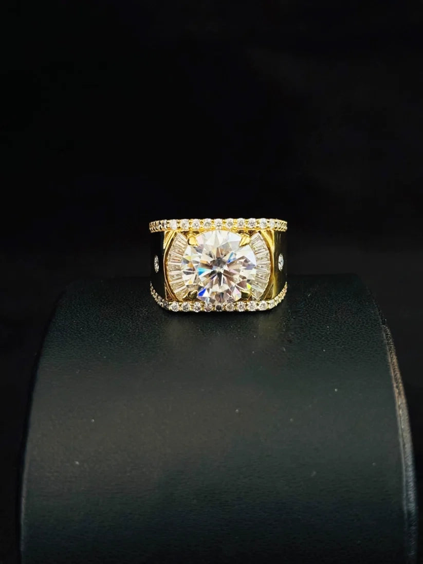 A yellow plated ring with a round-cut clear center stone and smaller accent stones along the band