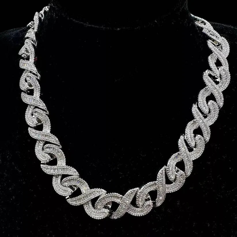 Silver baguette and round-cut diamond infinity link chain necklace displayed on a black bust