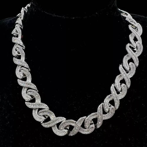 Silver baguette and round-cut diamond infinity link chain necklace displayed on a black bust