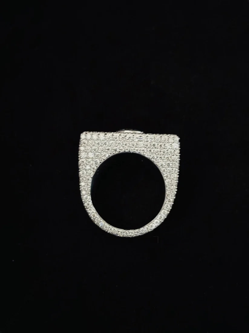 A silver dome-shaped ring paved with small diamond, shown against a solid black background.