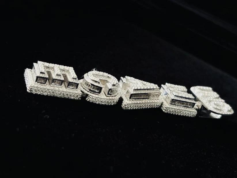 Custom iced out block letter name pendant in white gold with baguette diamonds