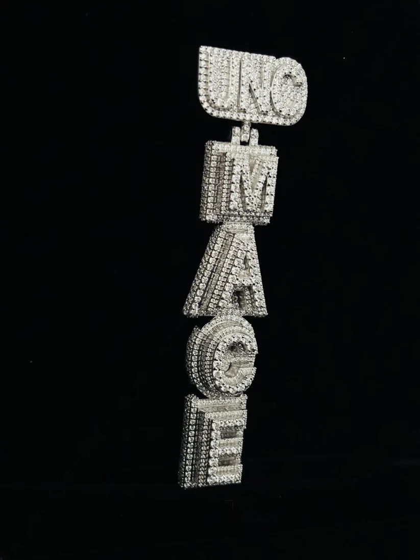 Vertical custom iced-out letter pendant featuring round and baguette-cut moissanite stones in a silver setting
