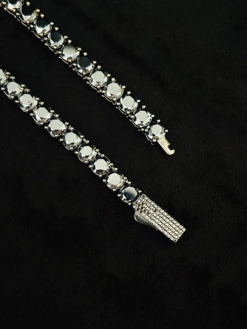 Silver tennis chain with a custom diamond iced-out clasp