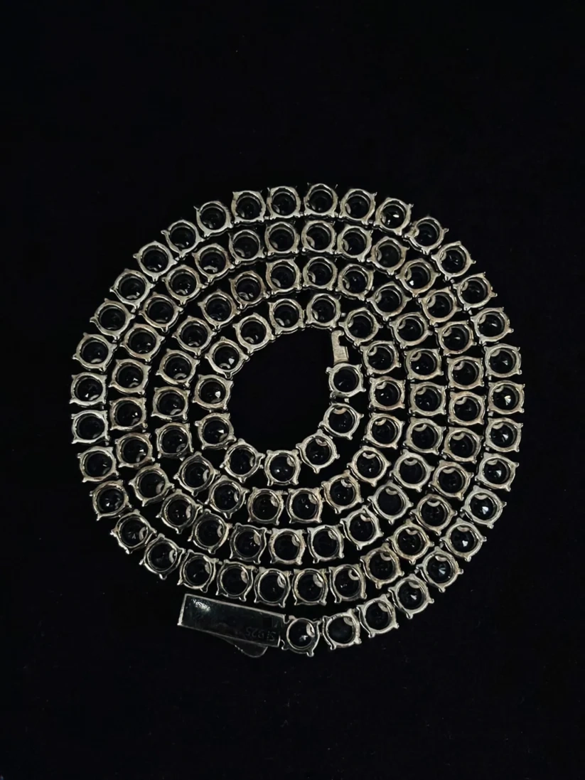 Coiled sterling silver tennis necklace set with round black onyx stones 