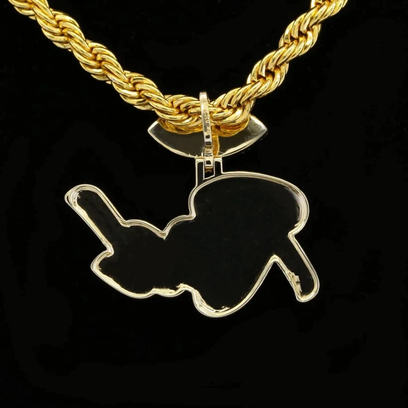 Gold rope chain necklace with a custom script name pendant against a black background.