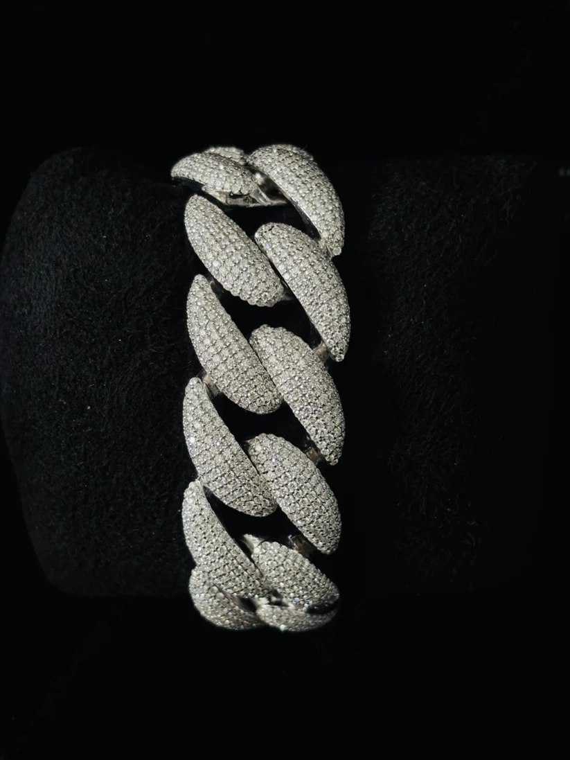 Close-up of a luxury silver diamond-encrusted Cuban link bracelet