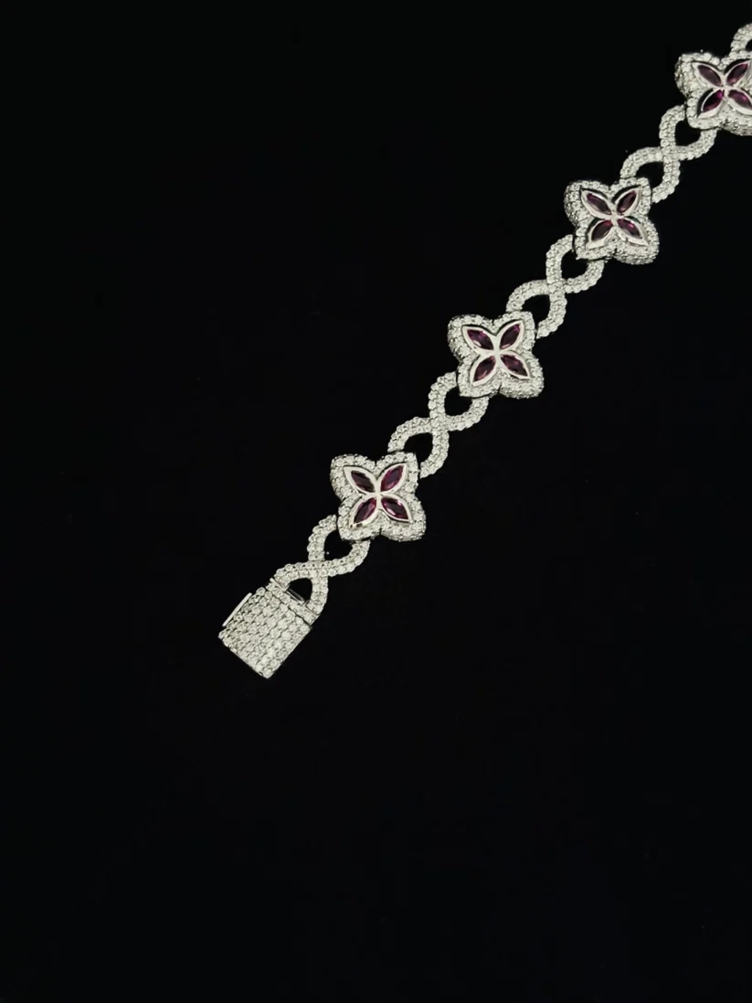 Luxury women's diamond statement bracelet with red ruby flower accents