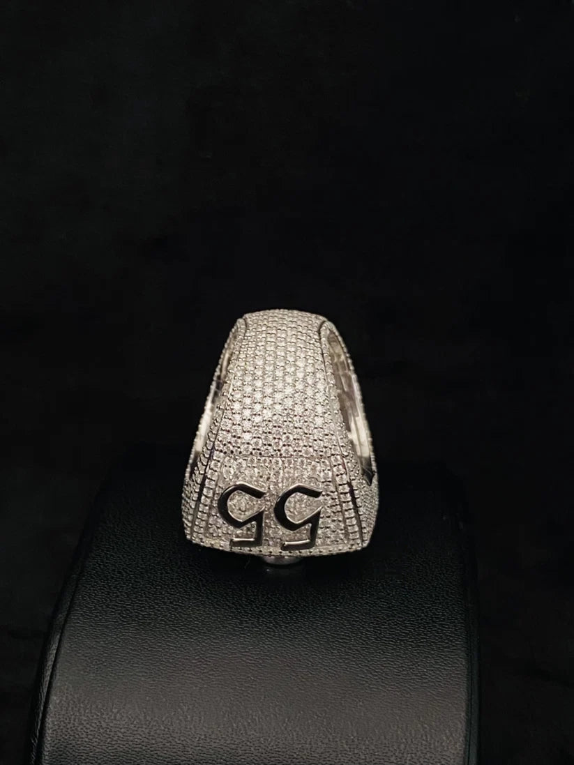 Pave diamond custom number 55 hip-hop ring on black display.