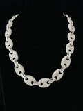 A front view silver chain necklace with textured oval links, displayed on a black velvet jewelry bust
