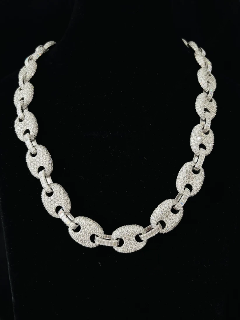 A front view silver chain necklace with textured oval links, displayed on a black velvet jewelry bust
