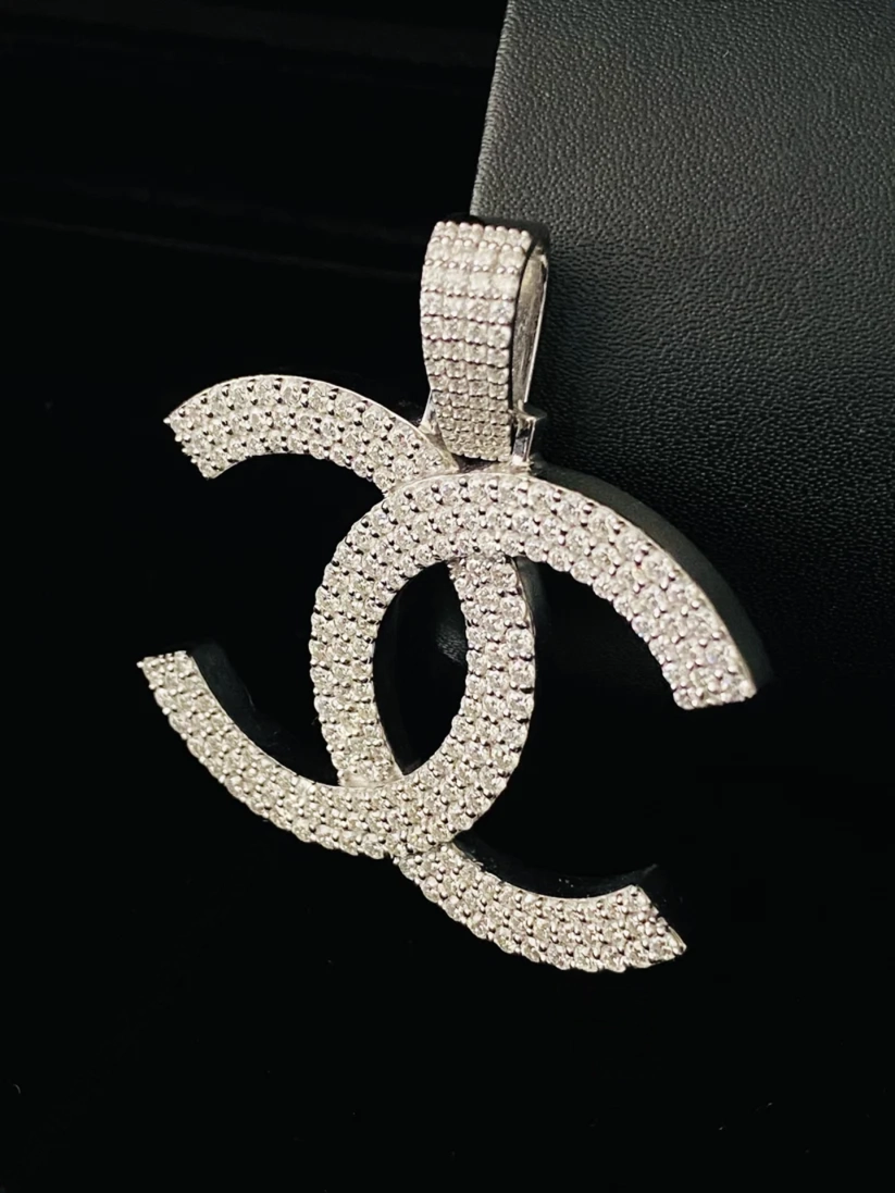 Silver diamond interlocking double C logo pendant necklace charm iced out with white pavé stones.
