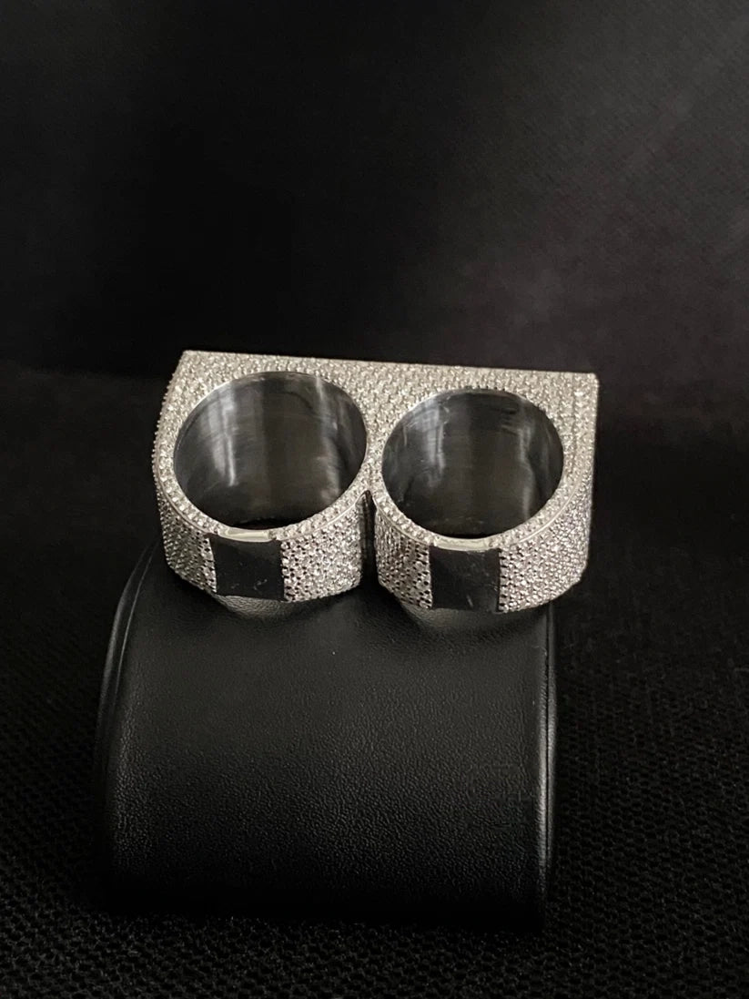 Silver iced out double finger ring featuring micro pavé simulated diamonds in a hip hop style.