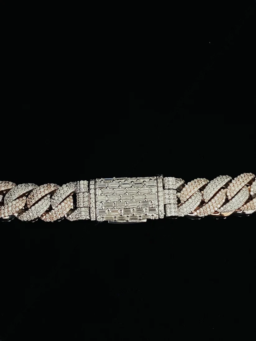 Close-up of a diamond Cuban link chain with a custom iced-out baguette clasp
