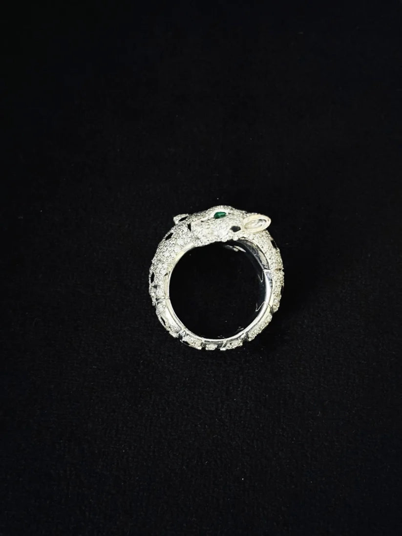 A tone view silver ring sculpted in the shape of a panther head, adorned with stones