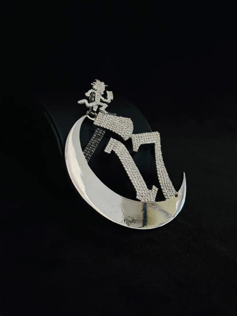 side view Custom iced out silver pendant with crescent moon number 17 and hatchetman logo