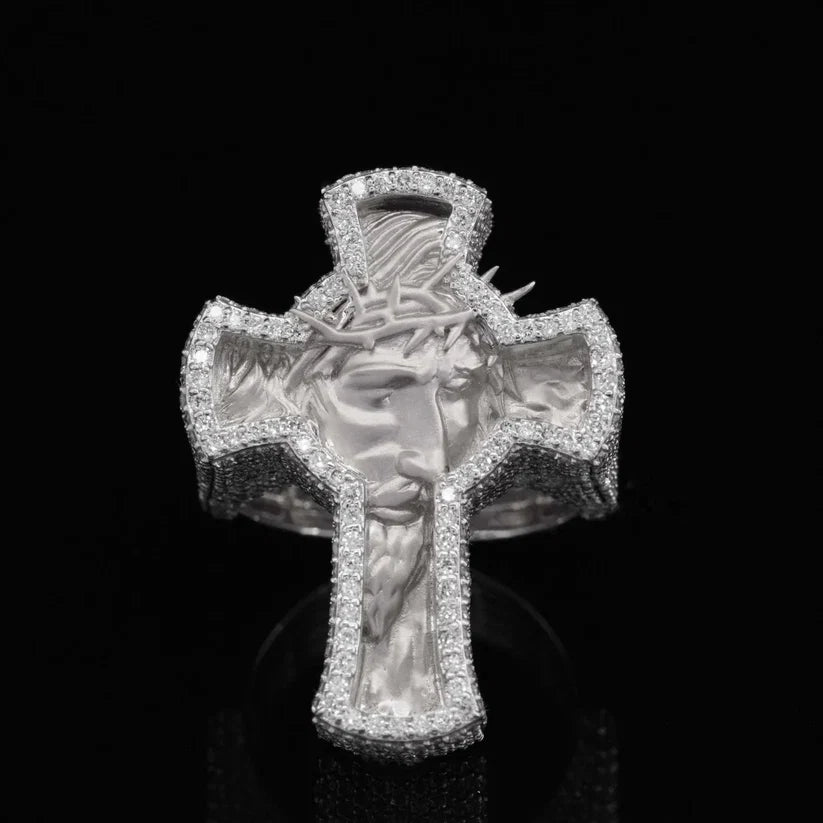 front view of the Intricate diamond-encrusted silver ring shaped like a cross with a relief carving of Jesus