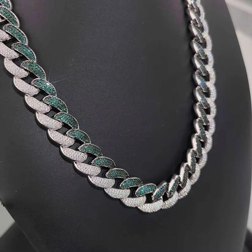 Silver Miami Cuban link chain necklace paved with white diamonds and green emeralds