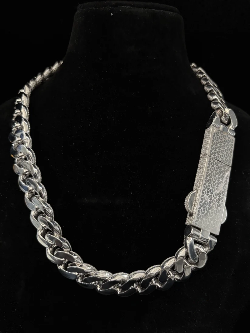 Men's thick silver cuban link chain featuring a luxury iced-out custom pave diamond clasp
