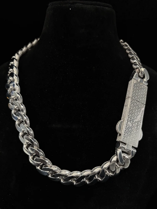 Men's thick silver cuban link chain featuring a luxury iced-out custom pave diamond clasp