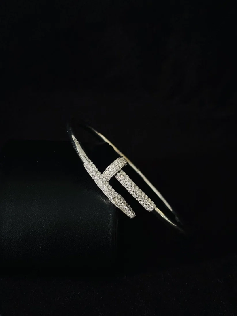 A Side view Silver nail-shaped cuff bracelet studded with Moissanite diamonds