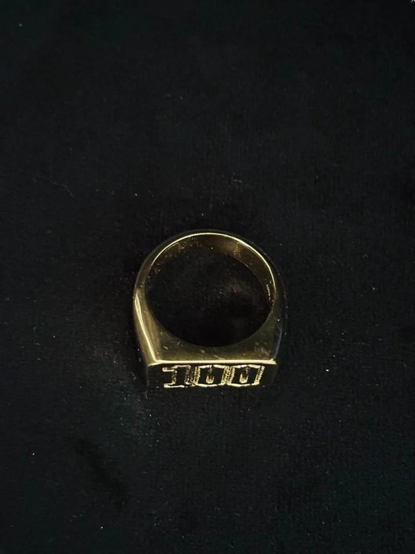 A top view Chunky statement ring with numerical engraving on black background