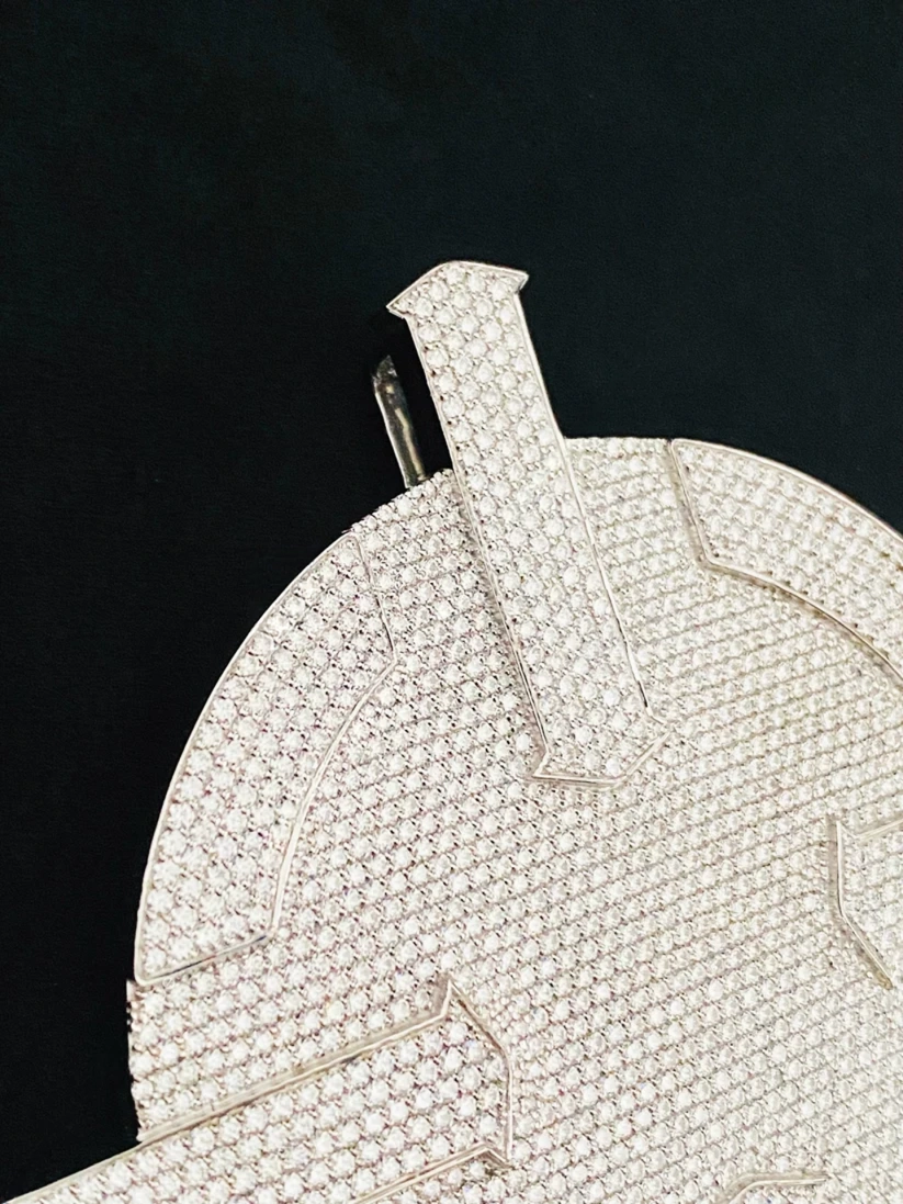 Iced out custom diamond pendant close up showing micropave setting details