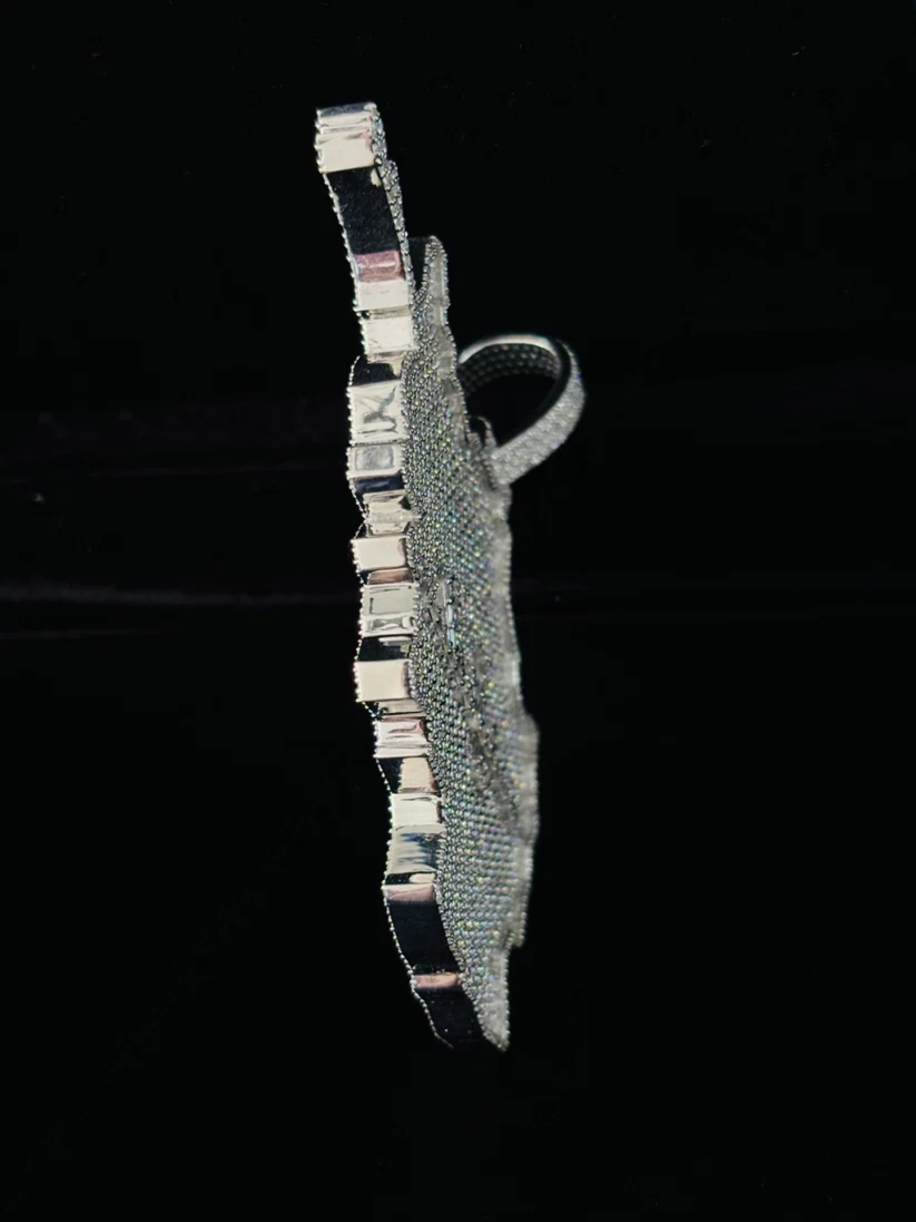 Side view of a custom iced-out diamond pendant in sterling silver with pave stones